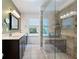 Bright bathroom featuring dual sinks, a window, and a glass-enclosed tiled shower at 784 Crestworth Xing, Powder Springs, GA 30127