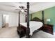 Bedroom featuring a four-poster bed, bedside tables, carpet flooring, and neutral walls at 784 Crestworth Xing, Powder Springs, GA 30127