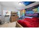 The bedroom offers a cozy space with a wooden bed frame and natural light, promoting a relaxing environment at 784 Crestworth Xing, Powder Springs, GA 30127