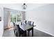 Charming dining room filled with natural light features a dark wood table with seating for six at 784 Crestworth Xing, Powder Springs, GA 30127
