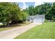Well-maintained single-Gathering home with a long driveway and a manicured lawn and landscaping at 784 Crestworth Xing, Powder Springs, GA 30127