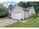 Exterior view of house showing siding, stone accents, two-car garage, and well maintained landscaping at 784 Crestworth Xing, Powder Springs, GA 30127