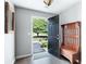 Open foyer with hardwood floors, a wooden bench, and view to the landscaped front yard at 784 Crestworth Xing, Powder Springs, GA 30127
