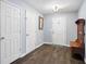 Foyer with hardwood floors, coat rack, and view of front door at 784 Crestworth Xing, Powder Springs, GA 30127