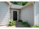 Close-up of the front door area, highlighting stone accents, landscaping, and walkway at 784 Crestworth Xing, Powder Springs, GA 30127