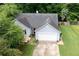 Charming one-story home with a gray roof, two car garage, and well-manicured lawn in a suburban neighborhood at 784 Crestworth Xing, Powder Springs, GA 30127