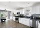 Bright kitchen with white cabinets, stainless appliances, black countertops, and an adjacent dining area at 784 Crestworth Xing, Powder Springs, GA 30127