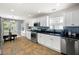 Bright kitchen with white cabinets, stainless steel appliances, granite countertops, and decorative backsplash at 784 Crestworth Xing, Powder Springs, GA 30127