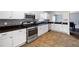 Well-equipped kitchen with modern appliances, white cabinetry, granite countertops, and tiled flooring at 784 Crestworth Xing, Powder Springs, GA 30127