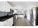 Spacious kitchen with white cabinets, stainless steel appliances, granite countertops, and tiled floors at 784 Crestworth Xing, Powder Springs, GA 30127