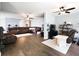 Open-concept living room with hardwood floors, ceiling fan, and lots of seating at 784 Crestworth Xing, Powder Springs, GA 30127