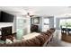 Open-concept living room featuring hardwood floors, fireplace, and large windows at 784 Crestworth Xing, Powder Springs, GA 30127