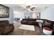 Spacious living room with hardwood floors, plush seating, ceiling fan, and stylish decor, perfect for relaxation at 784 Crestworth Xing, Powder Springs, GA 30127