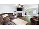 Cozy living room with a fireplace, ceiling fan, and a comfortable sofa at 784 Crestworth Xing, Powder Springs, GA 30127