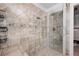Walk-in shower with a glass door and tiled walls, next to a tiled bench and linen closet for storage at 784 Crestworth Xing, Powder Springs, GA 30127