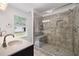 Tiled shower with glass door, a bench, and neutral-toned tile surround at 784 Crestworth Xing, Powder Springs, GA 30127