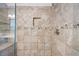 Close up of tiled shower with glass door, a bench, and a hand held shower wand at 784 Crestworth Xing, Powder Springs, GA 30127