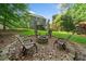 Backyard fire pit area with mature trees, a playset, and stairs to the deck at 150 Kensley Way, Dallas, GA 30157