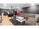 Finished basement with a gray sectional sofa, desk, and gym equipment at 150 Kensley Way, Dallas, GA 30157