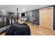 Finished basement with a barn door, weight bench, and entertainment area at 150 Kensley Way, Dallas, GA 30157