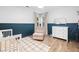 Bright bedroom with two-tone walls, wood floors, and a corner window at 150 Kensley Way, Dallas, GA 30157