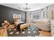 Stylish bedroom with wood-paneled wall, unique lighting, wood floors, and a comfy beanbag chair at 150 Kensley Way, Dallas, GA 30157