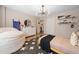 Modern bedroom features unique lighting fixture, wood floors, beanbag chair, and sporty decor at 150 Kensley Way, Dallas, GA 30157