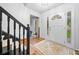 Foyer with view of stairs, coat closet, front door, and hardwood flooring at 150 Kensley Way, Dallas, GA 30157