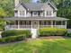 Charming two-story home featuring a welcoming front porch, well-manicured lawn, and lush landscaping at 150 Kensley Way, Dallas, GA 30157
