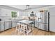 Bright and spacious kitchen with stainless steel appliances, light cabinets, and a center island at 150 Kensley Way, Dallas, GA 30157