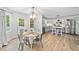 An open-concept kitchen and dining area offer modern appliances and lots of light at 150 Kensley Way, Dallas, GA 30157
