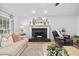 Bright living room featuring fireplace, mantle, hardwood flooring, neutral paint, and updated decor at 150 Kensley Way, Dallas, GA 30157