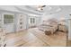 This is a bright main bedroom with a tray ceiling, a ceiling fan, and light colored wood flooring at 150 Kensley Way, Dallas, GA 30157