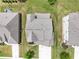 Aerial view of a well-maintained home with a landscaped yard, driveway, and mature trees at 4154 Hawking Dr, Suwanee, GA 30024