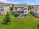 Expansive backyard showcasing a gray two-story home, a wooden deck with stairs, and lush green grass at 4154 Hawking Dr, Suwanee, GA 30024