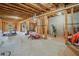 Spacious unfinished basement featuring a treadmill, an exterior door, and a utility area at 4154 Hawking Dr, Suwanee, GA 30024