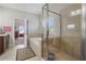 Bathroom featuring a glass-enclosed shower, soaking tub, and view to the primary bedroom at 4154 Hawking Dr, Suwanee, GA 30024