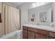 Bathroom with a vanity sink, cabinets, toilet, and shower with a neutral-colored shower curtain at 4154 Hawking Dr, Suwanee, GA 30024