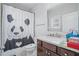 Bright bathroom featuring a panda shower curtain, dark wood vanity, and a neutral countertop at 4154 Hawking Dr, Suwanee, GA 30024