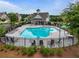 Community pool featuring a fenced-in area with lounge chairs, tables, and a central fountain at 4154 Hawking Dr, Suwanee, GA 30024