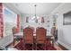 Bright dining room with a large window and elegant decorative curtains at 4154 Hawking Dr, Suwanee, GA 30024