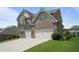Attractive two-story brick home with a two-car garage and a well-maintained lawn at 4154 Hawking Dr, Suwanee, GA 30024