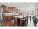 Kitchen area showcasing wood floors, an island with seating, and dark wood cabinetry at 4154 Hawking Dr, Suwanee, GA 30024