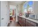 Bright kitchen featuring granite countertops, wood cabinets, and stainless steel appliances at 4154 Hawking Dr, Suwanee, GA 30024