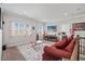 Bright living room with a decorative rug, wall-mounted TV, and comfortable seating arrangement at 4154 Hawking Dr, Suwanee, GA 30024