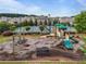 Community playground featuring a swing set, slide, picnic table, and tennis court in the background at 4154 Hawking Dr, Suwanee, GA 30024