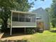 Backyard with a screened porch with a fan and a deck with stairs to the yard at 4164 River Shoals Ct, Duluth, GA 30097