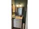 Bathroom with a white vanity and marble countertop, and a large mirror with a textured silver frame at 4164 River Shoals Ct, Duluth, GA 30097