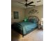 Comfortable bedroom featuring a black metal bed frame, a modern ceiling fan and a small decorative side table at 4164 River Shoals Ct, Duluth, GA 30097