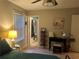 View of a bedroom leading to an ensuite bath, with a vanity and window to the left, and a decorated desk space at 4164 River Shoals Ct, Duluth, GA 30097